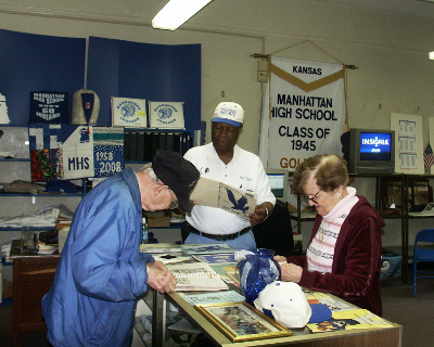 1944 class members are deep into the abundance of MHS history offered by the Alumni Center.
