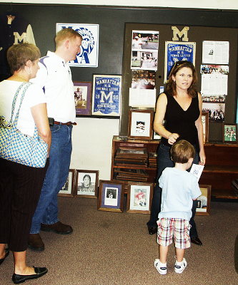 A Class of 1988 Mom converses while her son checks out the neat stuff in the Alumni Center.