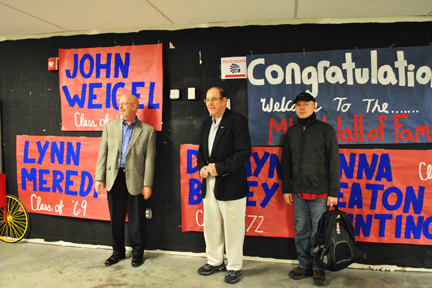Lynn Meredith, John Weigel, and Dawayne Bailey in front of the large WELCOME MHSAA sign made by MHS students.